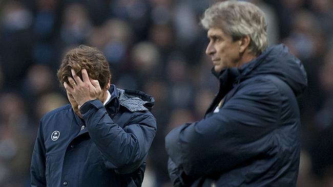 Tottenham's manager Andre Villas Boas, left, stands alongside colleague Manuel Pellegrini during his team's 6-0 loss to Manchester City in their English Premier League soccer match at the Etihad Stadium, Manchester, England, Sunday Nov. 24, 2013. (AP Photo/Jon Super)